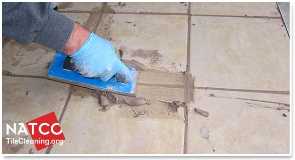 applying grout to tile floor