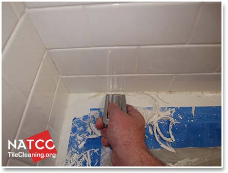 removing moldy caulk in a tile shower