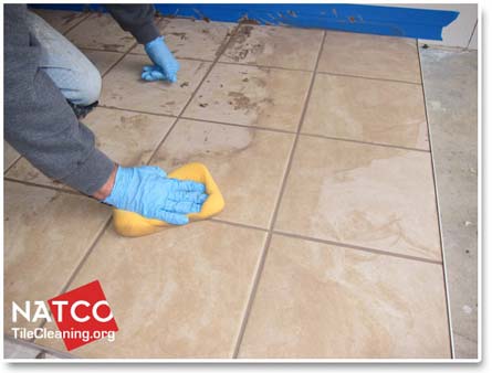 cleaning excess grout with grout sponge