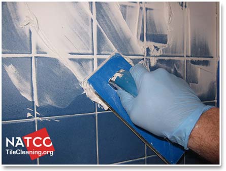 applying shower grout with a grout float