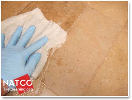 applying sealer to travertine floor tiles